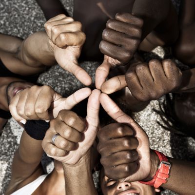 24726493 - a group of mixed race people with hands doing thumbs up